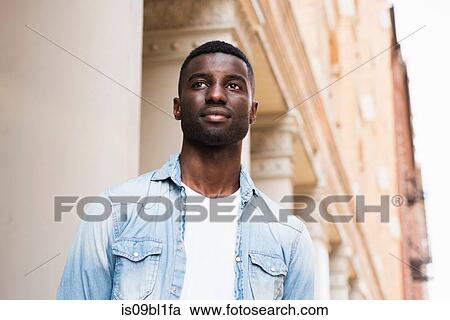 Stock Image - Young man in streets of New York, US. Fotosearch