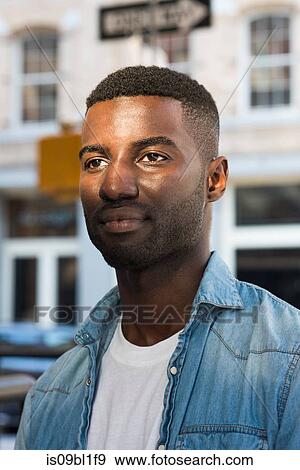 Stock Photo - Young man in streets of New York, US. Fotosearch