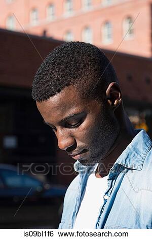 Stock Photograph - Young man in streets of New York, US. Fotosearch