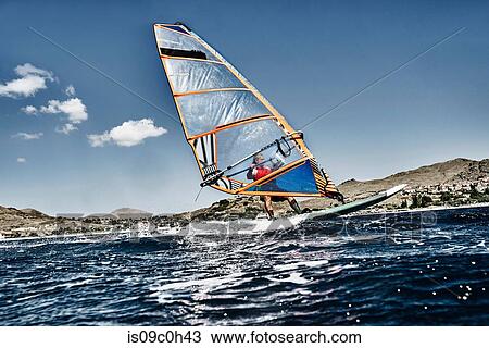 Young man leaning back windsurfing ocean waves, Limnos, Khios, Greece View Large Photo Image Stock Image - Young man leaning back windsurfing ocean waves, Limnos, Khios, Greece. Fotosearch