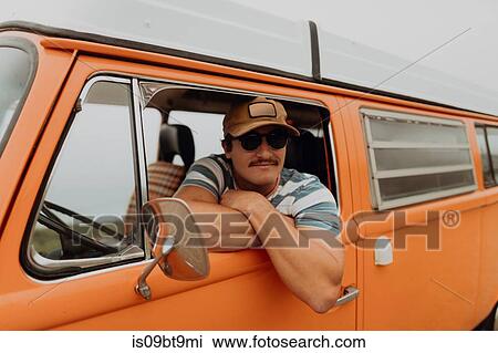 Young man leaning out of recreational vehicle window, portrait, Jalama, California, USA View Large Photo Image Stock Image - Young man leaning out of recreational vehicle window, portrait, Jalama, California, USA. Fotosearch