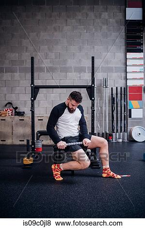 Young man massaging thigh with muscle roller stick in gym View Large Photo Image Stock Photo - Young man massaging thigh with muscle roller stick in gym. Fotosearch