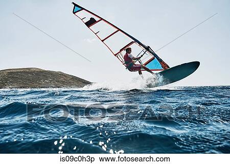 Young man mid air while windsurfing ocean waves, Limnos, Khios, Greece View Large Photo Image Stock Photography - Young man mid air while windsurfing ocean waves, Limnos, Khios, Greece. Fotosearch