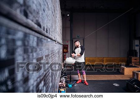 Picture - Young man powdering palms in gym. Fotosearch
