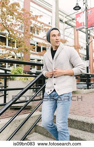 Stock Image - Young man walking down stairs, Yaletown, Vancouver, Canada. Fotosearch