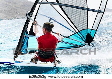 Young man windsurfing ocean wave, rear view, Limnos, Khios, Greece View Large Photo Image Stock Image - Young man windsurfing ocean wave, rear view, Limnos, Khios, Greece. Fotosearch