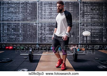 Young man working out in gym View Large Photo Image Stock Image - Young man working out in gym. Fotosearch