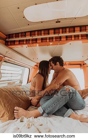 Young surfing couple face to face in back of recreational vehicle at beach, Jalama, California, USA View Large Photo Image Stock Photo - Young surfing couple face to face in back of recreational vehicle at beach, Jalama, California, USA. Fotosearch