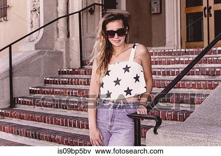Young woman by stairway View Large Photo Image Stock Photo - Young woman by stairway. Fotosearch