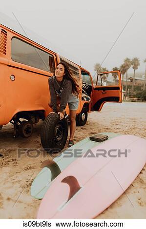 Young woman changing recreational vehicle tyre at beach, Jalama, California, USA View Large Photo Image Stock Photograph - Young woman changing recreational vehicle tyre at beach, Jalama, California, USA. Fotosearch