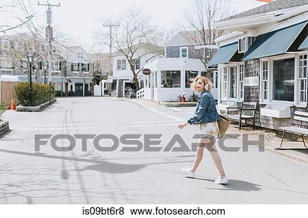 Young woman crossing road, portrait, Menemsha, Martha's Vineyard, Massachusetts, USA View Large Photo Image Stock Photo - Young woman crossing road, portrait, Menemsha, Martha's Vineyard, Massachusetts, USA. Fotosearch