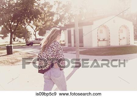 Young woman crossing street View Large Photo Image Stock Photo - Young woman crossing street. Fotosearch