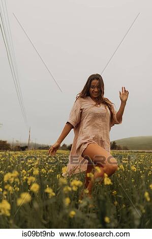 Young woman dancing in yellow wildflower field, Jalama, California, USA View Large Photo Image Stock Image - Young woman dancing in yellow wildflower field, Jalama, California, USA. Fotosearch