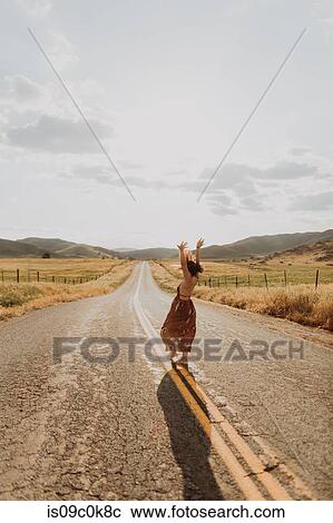 Young woman dancing on rural road, Exeter, California, USA View Large Photo Image Stock Image - Young woman dancing on rural road, Exeter, California, USA. Fotosearch