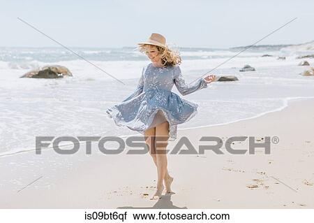 Young woman dancing on windy beach, Menemsha, Martha's Vineyard, Massachusetts, USA View Large Photo Image Stock Image - Young woman dancing on windy beach, Menemsha, Martha's Vineyard, Massachusetts, USA. Fotosearch