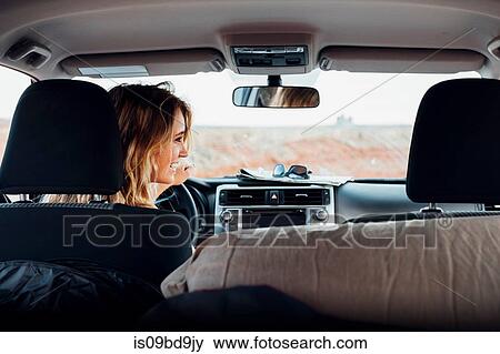 Young woman driving vehicle in remote setting, rear view, vehicle interior, Mexican Hat, Utah, USA View Large Photo Image Stock Photo - Young woman driving vehicle in remote setting, rear view, vehicle interior, Mexican Hat, Utah, USA. Fotosearch