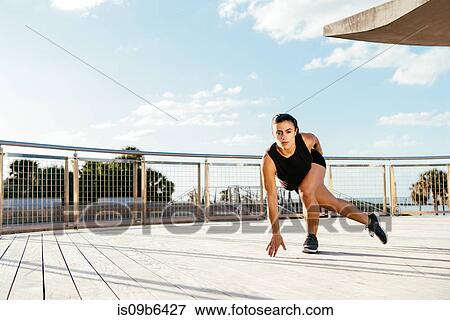 Stock Photo - Young woman exercising outdoors, South Point Park, Miami Beach, Florida, USA. Fotosearch