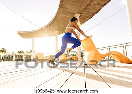 Young woman exercising outdoors, holding chair for balance, low angle view, South Point Park, Miami Beach, Florida, USA View Large Photo Image Stock Photography - Young woman exercising outdoors, holding chair for balance, low angle view, South Point Park, Miami Beach, Florida, USA. Fotosearch