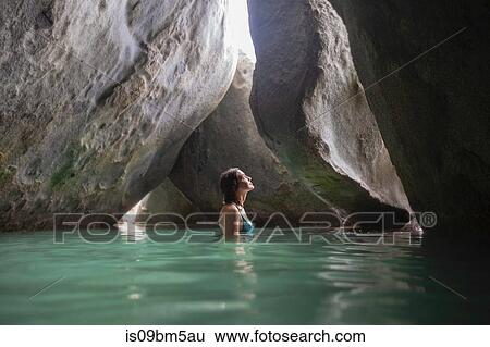 Young woman exploring flooded grotto, Virgin Gorda, British Virgin Islands View Large Photo Image Stock Photograph - Young woman exploring flooded grotto, Virgin Gorda, British Virgin Islands. Fotosearch