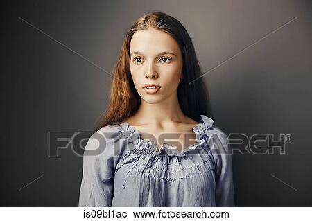 Young woman, grey background View Large Photo Image Stock Image - Young woman, grey background. Fotosearch