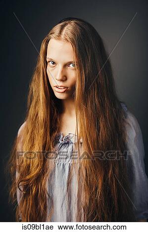 Stock Image - Young woman, grey background. Fotosearch