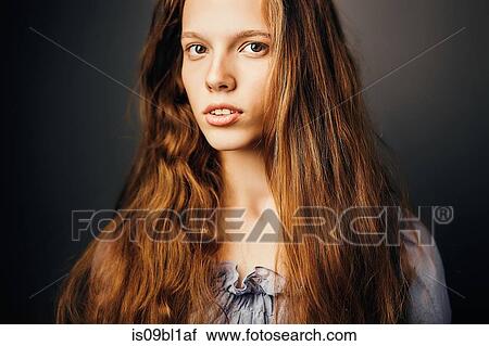 Stock Image - Young woman, grey background. Fotosearch