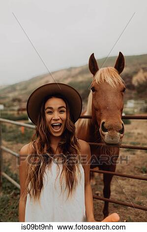 Young woman in felt hat next to horse, portrait, Jalama, California, USA View Large Photo Image Stock Image - Young woman in felt hat next to horse, portrait, Jalama, California, USA. Fotosearch