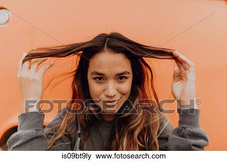 Young woman in front of orange recreational vehicle at beach, portrait, Jalama, California, USA View Large Photo Image Stock Photo - Young woman in front of orange recreational vehicle at beach, portrait, Jalama, California, USA. Fotosearch
