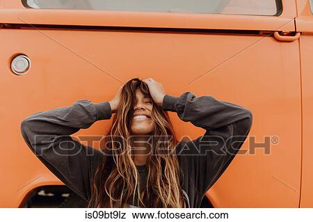 Young woman in front of orange recreational vehicle at beach, portrait, Jalama, California, USA View Large Photo Image Stock Photo - Young woman in front of orange recreational vehicle at beach, portrait, Jalama, California, USA. Fotosearch