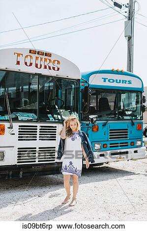 Young woman in front of tour buses, Menemsha, Martha's Vineyard, Massachusetts, USA View Large Photo Image Stock Photography - Young woman in front of tour buses, Menemsha, Martha's Vineyard, Massachusetts, USA. Fotosearch