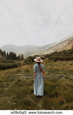 Young woman in stetson and maxi dress strolling in rural valley, rear view, Mineral King, California, USA View Large Photo Image Stock Image - Young woman in stetson and maxi dress strolling in rural valley, rear view, Mineral King, California, USA. Fotosearch