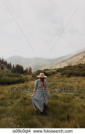 Young woman in stetson holding maxi dress in rural valley, Mineral King, California, USA View Large Photo Image Picture - Young woman in stetson holding maxi dress in rural valley, Mineral King, California, USA. Fotosearch