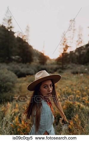 Young woman in stetson looking over her shoulder in rural valley, portrait, Mineral King, California, USA View Large Photo Image Stock Photography - Young woman in stetson looking over her shoulder in rural valley, portrait, Mineral King, California, USA. Fotosearch