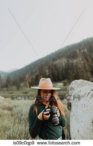 Young woman in stetson reviewing photos on digital camera in rural valley, Mineral King, California, USA View Large Photo Image Stock Photo - Young woman in stetson reviewing photos on digital camera in rural valley, Mineral King, California, USA. Fotosearch