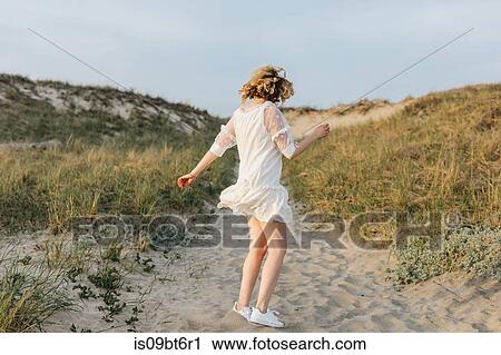 Young woman in white dress dancing on coastal dunes, Menemsha, Martha's Vineyard, Massachusetts, USA View Large Photo Image Stock Image - Young woman in white dress dancing on coastal dunes, Menemsha, Martha's Vineyard, Massachusetts, USA. Fotosearch