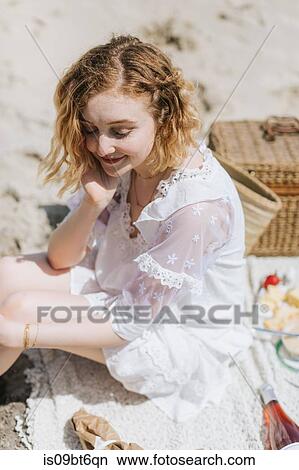 Young woman in white dress sitting on picnic blanket at beach, Menemsha, Martha's Vineyard, Massachusetts, USA View Large Photo Image Picture - Young woman in white dress sitting on picnic blanket at beach, Menemsha, Martha's Vineyard, Massachusetts, USA. Fotosearch