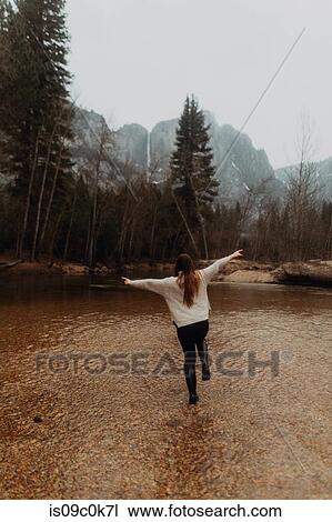 Young woman jumping in river shallows, rear view, Yosemite Village, California, USA View Large Photo Image Stock Image - Young woman jumping in river shallows, rear view, Yosemite Village, California, USA. Fotosearch