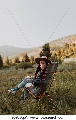 Young woman looking back from deck chair in rural valley, portrait, Mineral King, California, USA View Large Photo Image Stock Image - Young woman looking back from deck chair in rural valley, portrait, Mineral King, California, USA. Fotosearch