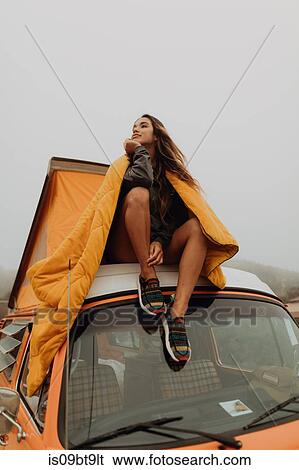 Young woman looking out from top of recreational vehicle at beach, Jalama, California, USA View Large Photo Image Stock Photograph - Young woman looking out from top of recreational vehicle at beach, Jalama, California, USA. Fotosearch