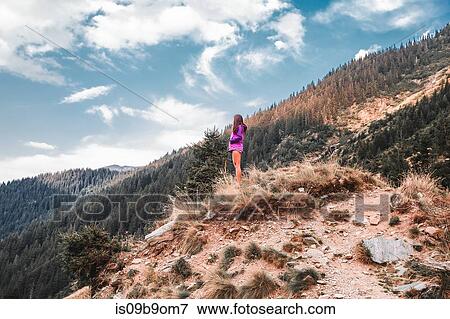 Young woman looking out over mountain forest landscape, Draja, Vaslui, Romania View Large Photo Image Stock Photo - Young woman looking out over mountain forest landscape, Draja, Vaslui, Romania. Fotosearch