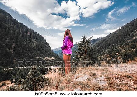 Young woman looking out over valley forest landscape, Draja, Vaslui, Romania View Large Photo Image Stock Photo - Young woman looking out over valley forest landscape, Draja, Vaslui, Romania. Fotosearch