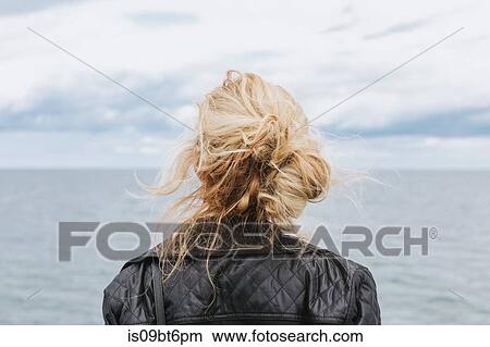 Young woman looking out to sea, rear view, Menemsha, Martha's Vineyard, Massachusetts, USA View Large Photo Image Picture - Young woman looking out to sea, rear view, Menemsha, Martha's Vineyard, Massachusetts, USA. Fotosearch