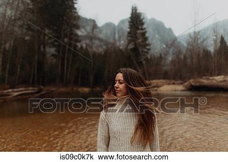 Young woman on riverbank shaking long brown hair, Yosemite Village, California, USA View Large Photo Image Stock Image - Young woman on riverbank shaking long brown hair, Yosemite Village, California, USA. Fotosearch
