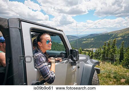 Young woman on road trip looking out from parked off road vehicle, Breckenridge, Colorado, USA View Large Photo Image Stock Image - Young woman on road trip looking out from parked off road vehicle, Breckenridge, Colorado, USA. Fotosearch