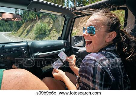 Young woman on road trip with boyfriend laughing at instant photograph, Breckenridge, Colorado, USA View Large Photo Image Picture - Young woman on road trip with boyfriend laughing at instant photograph, Breckenridge, Colorado, USA. Fotosearch
