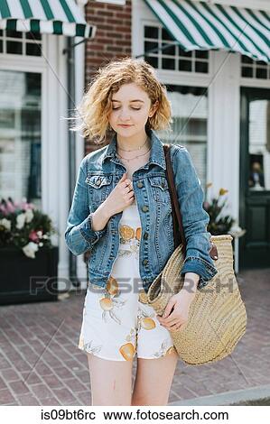 Young woman on street carrying straw bag, Menemsha, Martha's Vineyard, Massachusetts, USA View Large Photo Image Stock Image - Young woman on street carrying straw bag, Menemsha, Martha's Vineyard, Massachusetts, USA. Fotosearch