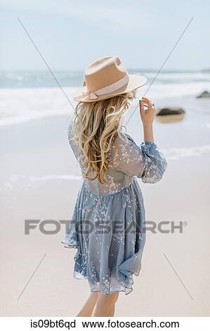 Young woman on windy beach, rear view, Menemsha, Martha's Vineyard, Massachusetts, USA View Large Photo Image Stock Image - Young woman on windy beach, rear view, Menemsha, Martha's Vineyard, Massachusetts, USA. Fotosearch