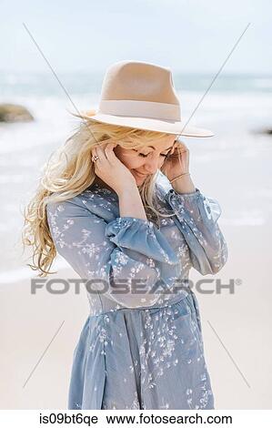 Young woman on windy beach with hands in hair, Menemsha, Martha's Vineyard, Massachusetts, USA View Large Photo Image Stock Image - Young woman on windy beach with hands in hair, Menemsha, Martha's Vineyard, Massachusetts, USA. Fotosearch