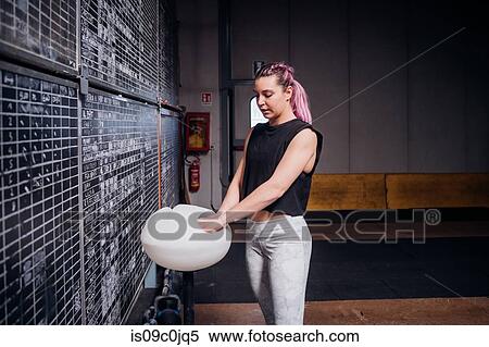 Young woman powdering palms in gym View Large Photo Image Stock Photography - Young woman powdering palms in gym. Fotosearch