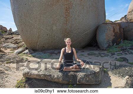 Young woman practicing lotus yoga pose on beach rock, portrait, Cape Town, Western Cape, South Africa View Large Photo Image Stock Image - Young woman practicing lotus yoga pose on beach rock, portrait, Cape Town, Western Cape, South Africa. Fotosearch